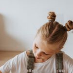 Online Learning - Little Girl Writing on a Notebook