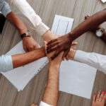 Work Environment - Man and Woman Holding Each Other's Hands As A Team