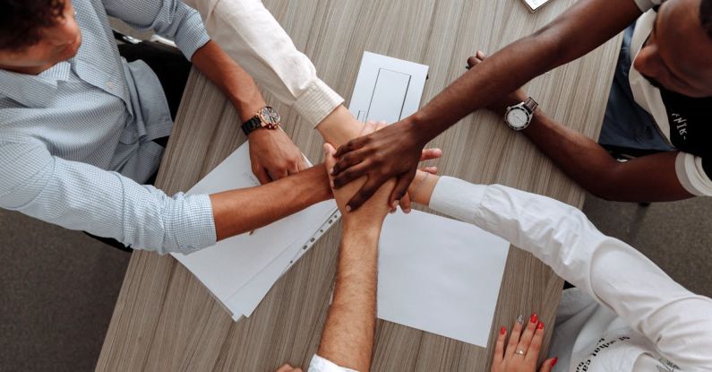 Work Environment - Man and Woman Holding Each Other's Hands As A Team