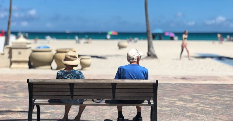 Retirement - Man and Woman Sitting on Brown Wooden Bench