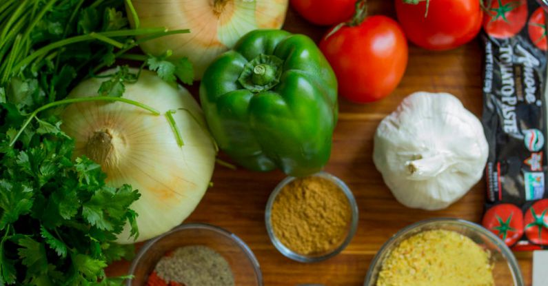 Groceries - Assorted Vegetables and Spices on Wood Surface