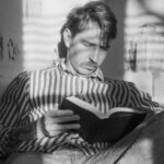 Speed Reading - Man Sitting with Book in Black and White