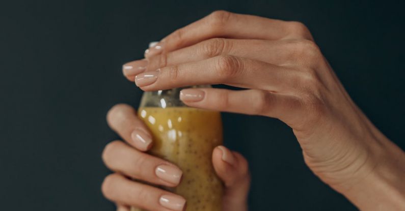 Diet And Exercise - Person Holding Clear Glass Jar With Yellow Liquid