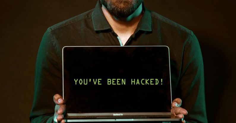 Hacks - Man Holding Laptop Computer With Both Hands