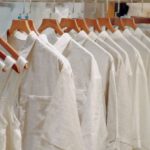 Capsule Wardrobe - Clothes in Neutral Colors Hanging on the Racks in a Clothing Store